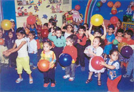 Tiny tots of Swiss International Play School play with balls and balloons during a party held in the school