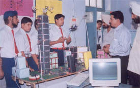 A student shows a scientific model to Mr Varinder Sharma, District Science Superviser