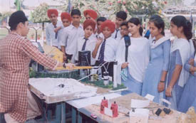 A student shows a scientific model to other students during a tehsil-level science exhibition organised at Guru Nanak Khalsa High School