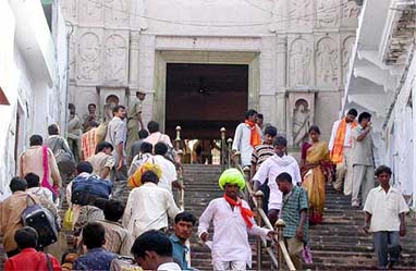 Devotees enter the Hanuman Gadi near the disputed area of Ram Mandir for darshan