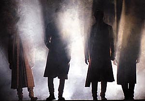 Off the ramp: Models wait in the shadows for the arc lights.