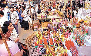 DIVALI DAZZLE: Visitors admire decorative miniature dolls on the occasion of Divali at Chandni Chowk in the Capital on Thursday. 