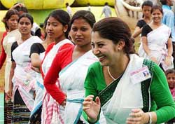 Folk dancers from different states share a light moment following the final rehearsal of the opening ceremony of the first Afro-Asian Games in Hyderabad 