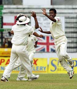 Bangladeshi bowler Enamul Haque Jr celebrates with teammates after dismissing English batsman Chris Read