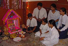 Students of Sanatan Vidya Mandir perform puja as a part of the Divali celebrations in the school