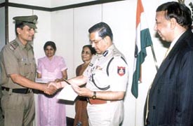 Delhi Police Commissioner R. S. Gupta awarding certificates in Forensic Sciences to a police officer at a function in the Police Headquarters in the Capital