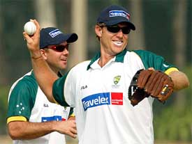 Australian cricketer Matthew Hayden throws a ball in front of his captain Ricky Ponting during a practice session