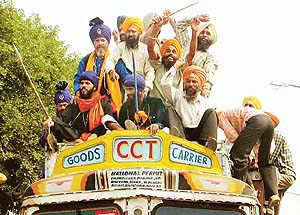 Protesters atop a truck raise anti-government slogans in SAS Nagar