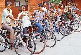 Slum kids associated with Theatre Age flaunt their brand new bicycles gifted to them on Divali by The Tribune and Avon