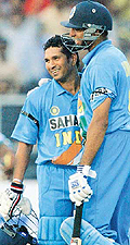 Sachin Tendulkar gets a hug from teammate VVS Laxman after scoring a century against Australia during the second one-day tri-nation tournament match in Gwalior on Sunday.