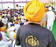 Shouldering the responsibility of keeping Sikh unity intact, a visitor makes an entry to the venue of the World Sikh Convention held at Mohali on Sunday.
