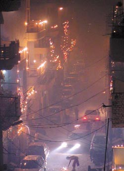 A thick pall of smoke hangs overhead in the Capital on Divali night