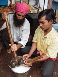 Blacksmiths clean their tools with milk on the occasion of Vishvakarma Day in Amritsar on Sunday. 