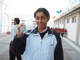 Richa Mishra shows her silver medal 