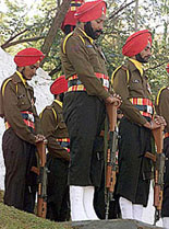 Soldiers of the Sikh Regiment bow their heads as mark of respect to fallen colleagues at a ceremony to mark Infantry Day in Baramula, 54 km north of Srinagar