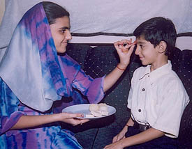 A sister applies �tilak� on the forehead of her brother on Bhaiya Dooj