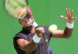Prakash Amritraj returns the ball against Sunday Maku of Nigeria during the men�s singles team final match 