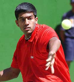 Rohan Bopanna returns the ball to Rotimi Jegede of Nigeria