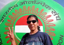 Shooter Deepali Deshpande of India flashes a victory sign after winning the silver medal 
