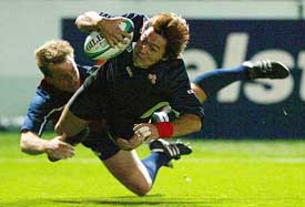 Mike Hercus of the US tackles Daisuke Ohata of Japan as he scores a try during their Rugby World Cup match 