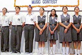 Students of Bhavan Vidyalaya, Sector 27, present a group song at Government Art Museum in Sector 10, Chandigarh, on Tuesday.