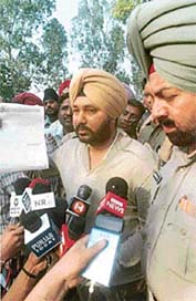 Popstar Daler Mehndi shows documents of his visits abroad to newsmen in Patiala on Tuesday. 