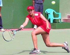 Sania Mirza hits a forehand return to Fadzai Mawisire of Zimbabwe 