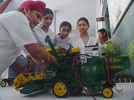 A student demonstrates the working of advanced agricultural machinery through his model at the exhibition