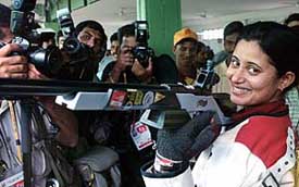 Anjali Vedpathak Bhagwat poses for photographers after the women�s 50 m sport rifle three position event