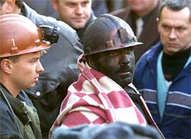 A rescued miner is led out of a mine in Russia�s southern town of Novoshakhtinsk 