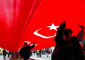 Turkish students cheer under the world's longest national flag