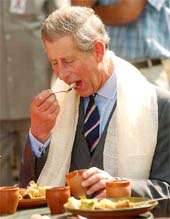 Prince Charles tastes Indian food during his visit to a stall at Dilli Haat in New Delhi
