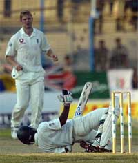 Bangladeshi batsman Rajin Saleh avoids a bouncer as England bowler Matthew Hoggard charges down the pitch 