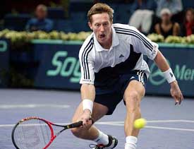 Jonas Bjorkman of Sweden returns the ball to Gregory Carraz of France during their third round match at the ATP Masters Series in Paris 