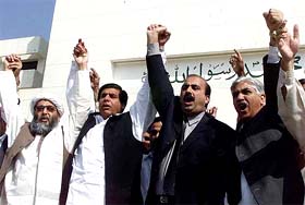 Pakistan�s Opposition lawmakers chant anti-government slogans during a protest against the arrest of one of their key leaders in front of Parliament House in Islamabad