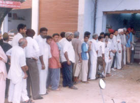 People wait in long queues for their turn at Amloh post office