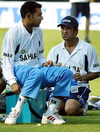 Virender Sehwag  and Sachin Tendulkar chat during a practice session