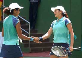 Sania Mirza and Rusmi Chakravarthy shake hands after winning the women�s doubles final against Stefanie Rosa Maya and Septi Mende of Indonesia