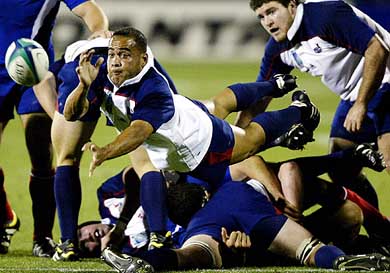Kevin Dalzell of the US dives as he passes the ball during their Rugby World Cup match against France 