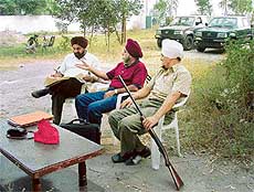 Col B.S. Guraya (retd), Chairman of Titan Motors Pvt Ltd, (centre) and Mr B.S. Bedi (left), Managing Director, camp at the disputed land
