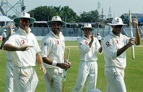 England players walk back to the pavilion after winning the match against Bangladesh