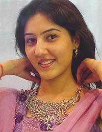 A model displays a necklace at a jewellery exhibition