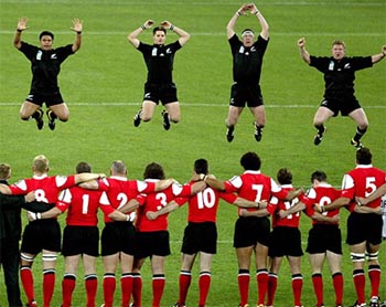 The Welsh rugby team watch as members of the All Blacks perform the Haka at the start of their rugby World Cup match at Sydney's Olympic Stadium 
