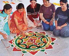 Students decorate a rangoli at Zone A Youth Festival which began at the Guru Gobind Singh College, Sector 26