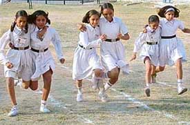Girls of Swami Ram Tirath Public School take part in three-legged race as part of its annual sports day in Phase IV