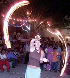 A foreigner exhibits her skill with fire engulfed in a string during the Pushkar Fair
