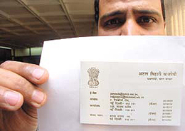 A Delhi Police Crime Branch Economic Offences wing officer shows the fake visiting card of Prime Minister