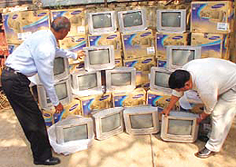 A sleuth of the Delhi Police Crime Branch showing the TV sets, stolen from a cargo depot, meant for export to Finland in the Capital