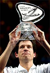 Tim Henman of the UK holds up his trophy after defeating Andrei Pavel of Romania in the final of the Paris Masters indoor tennis tournament in Paris 