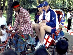 England cricketers Andrew Flintoff and James Anderson ride a rickshaw at a children's home in Sreepur
